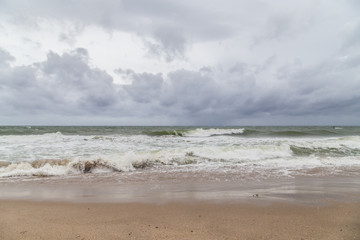 Fototapeta na wymiar Dark sky and wave/the day at the beach Hurricane Matthew hit Florida