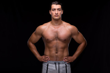 Ripped muscular man on black background