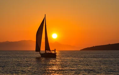 Photo sur Plexiglas Mer / coucher de soleil Bateau à voile sur la mer au coucher du soleil.