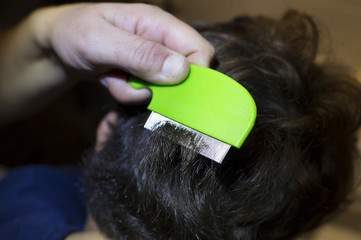 .Mother Checking Daughters Hair For Head Louse