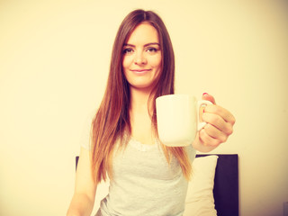 Cheerful girl drinking coffee.