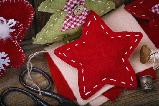 Christmas ornaments and tools to create them on the wooden table