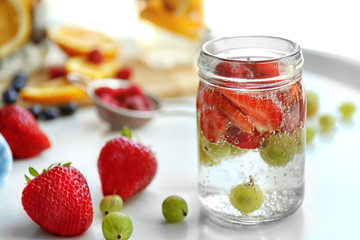 Fototapeta na wymiar Refreshing water with fruits on table