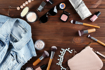 Flat lay of women cosmetics and accessories on wooden background