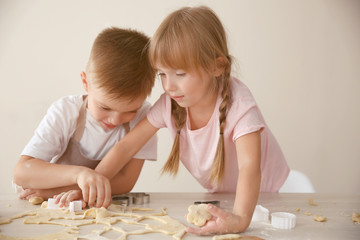 Kids making biscuits in kitchen