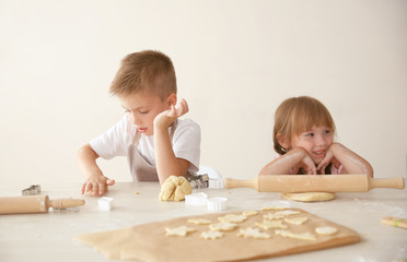 Obraz na płótnie Canvas Kids making biscuits in kitchen