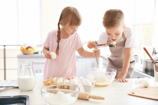Kids making dough in kitchen
