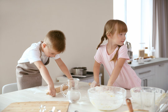 Kids making biscuits in kitchen
