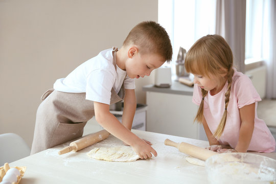 Kids making biscuits in kitchen