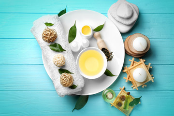 Spa composition with tea tree oil on blue wooden background