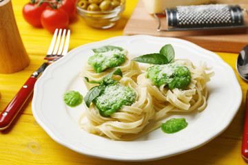 Delicious tagliatelle pasta with ingredients on wooden table