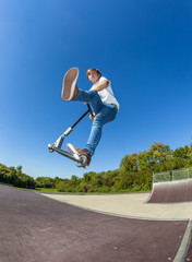 boy jumping with his scooter © travelview
