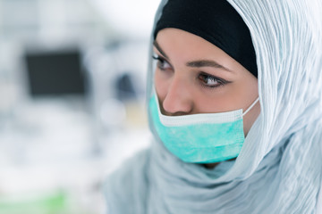 Dental prosthesis, dentures, prosthetics work. Arab students with hijab while working on the denture, false teeth, a study and a table with dental tools