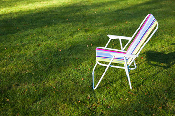 garden chair on green grass background