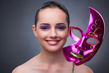 Young woman with carnival mask
