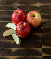 Naklejka na ściany i meble Apples and sliced Apples on a wood cutting board