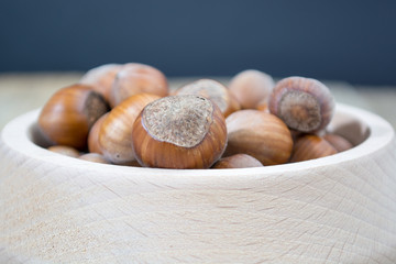 Wooden bowl full of hazzelnuts