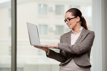 Young businesswoman working with laptop in business concept