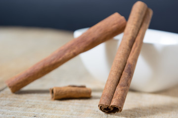 Cinnamon sticks in a white bowl