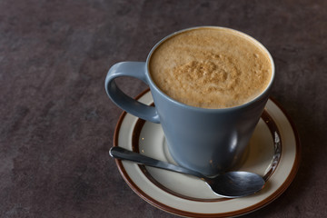 hot fresh coffee blue cup with silver spoon on black table at coffee time topview / hot fresh coffee