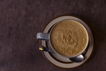 hot fresh coffee blue cup with silver spoon on black table at coffee time topview / hot fresh coffee