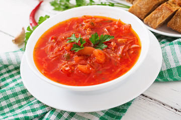 Traditional Ukrainian Russian vegetable borscht on the white wooden background