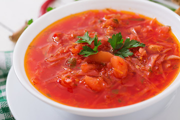 Traditional Ukrainian Russian vegetable borscht on the white wooden background