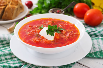Traditional Ukrainian Russian vegetable borscht on the white wooden background