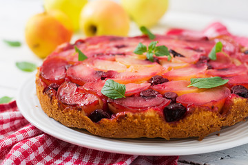 Delicate biscuit cake with apples and cherries.
