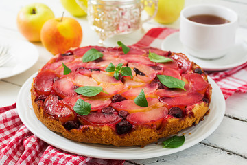 Delicate biscuit cake with apples and cherries.