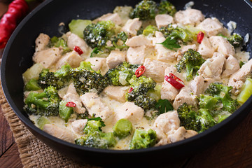 Delicate saute chicken with broccoli and chili peppers in a creamy garlic sauce