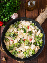 Delicate saute chicken with broccoli and chili peppers in a creamy garlic sauce. Top view