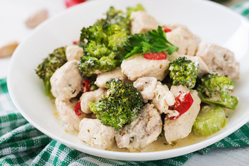 Delicate saute chicken with broccoli and chili peppers in a creamy garlic sauce
