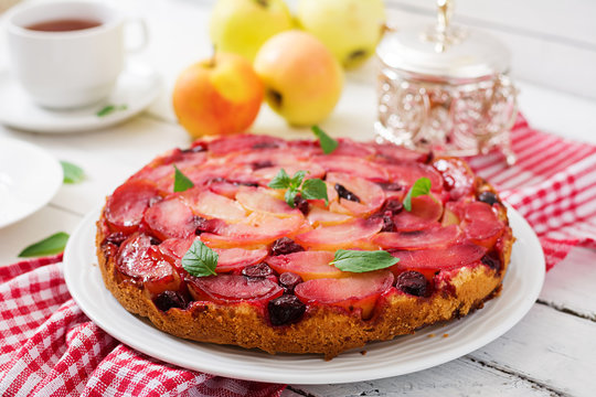 Delicate biscuit cake with apples and cherries.