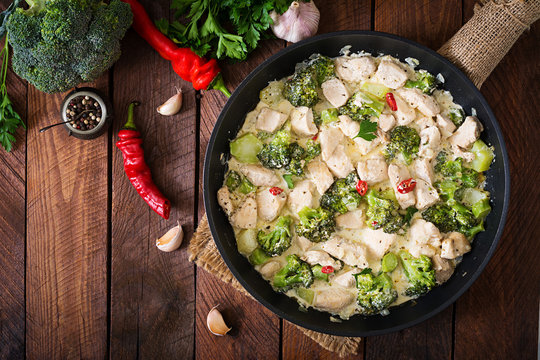 Delicate saute chicken with broccoli and chili peppers in a creamy garlic sauce. Top view