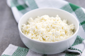 Organic cottage cheese in a white ceramic bowl on the kitchen ta