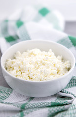 Organic cottage cheese in a white ceramic bowl on the kitchen ta