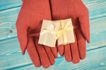 Vintage photo, Hands of woman in gloves with gifts for Christmas or other celebration