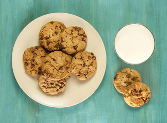 Chocolate chips cookies with glass of milk, shot from above