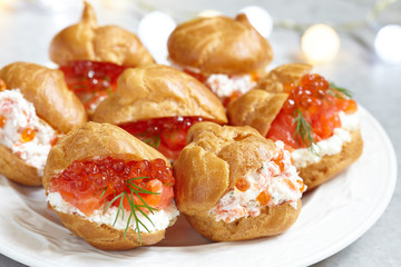 Profiteroles with fish and red caviar