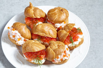Profiteroles with fish and red caviar