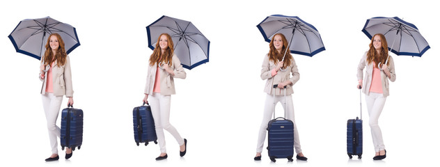 Young woman travelling with suitcase and umbrella isolated on wh