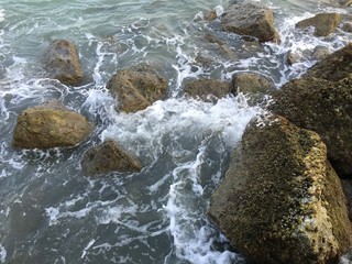 Rocky beach by the sea wave refreshing atmosphere.