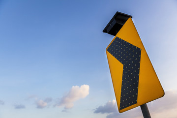 yellow traffic label in blue sky