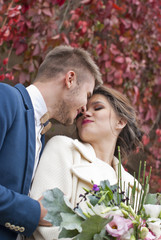 Bride and groom while smiling and looking to each other 