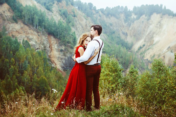 the couple stands in the mountains