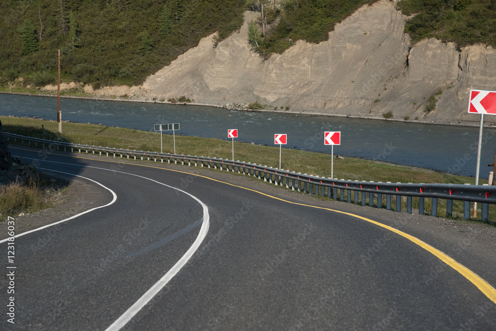 Wall mural asphalt winding road in the mountainous area in the summer and s