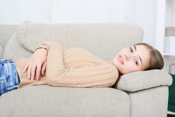 smiling young woman lying on couch