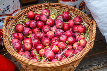 Red ripe apples lying in a wicker basket.