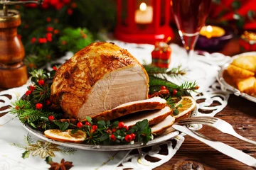 Muurstickers Christmas baked ham, served on the old plate. © gkrphoto